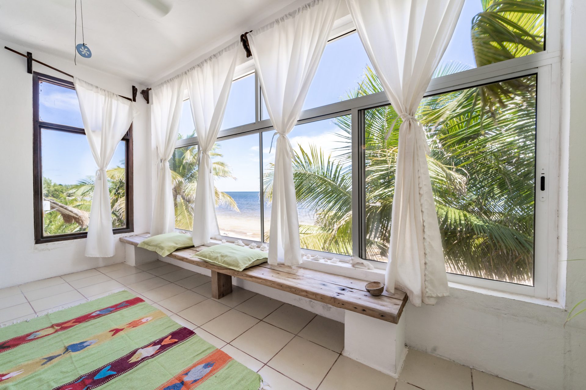 Room Earth — panoramic view, two beds with blue bedding, blue fish rug